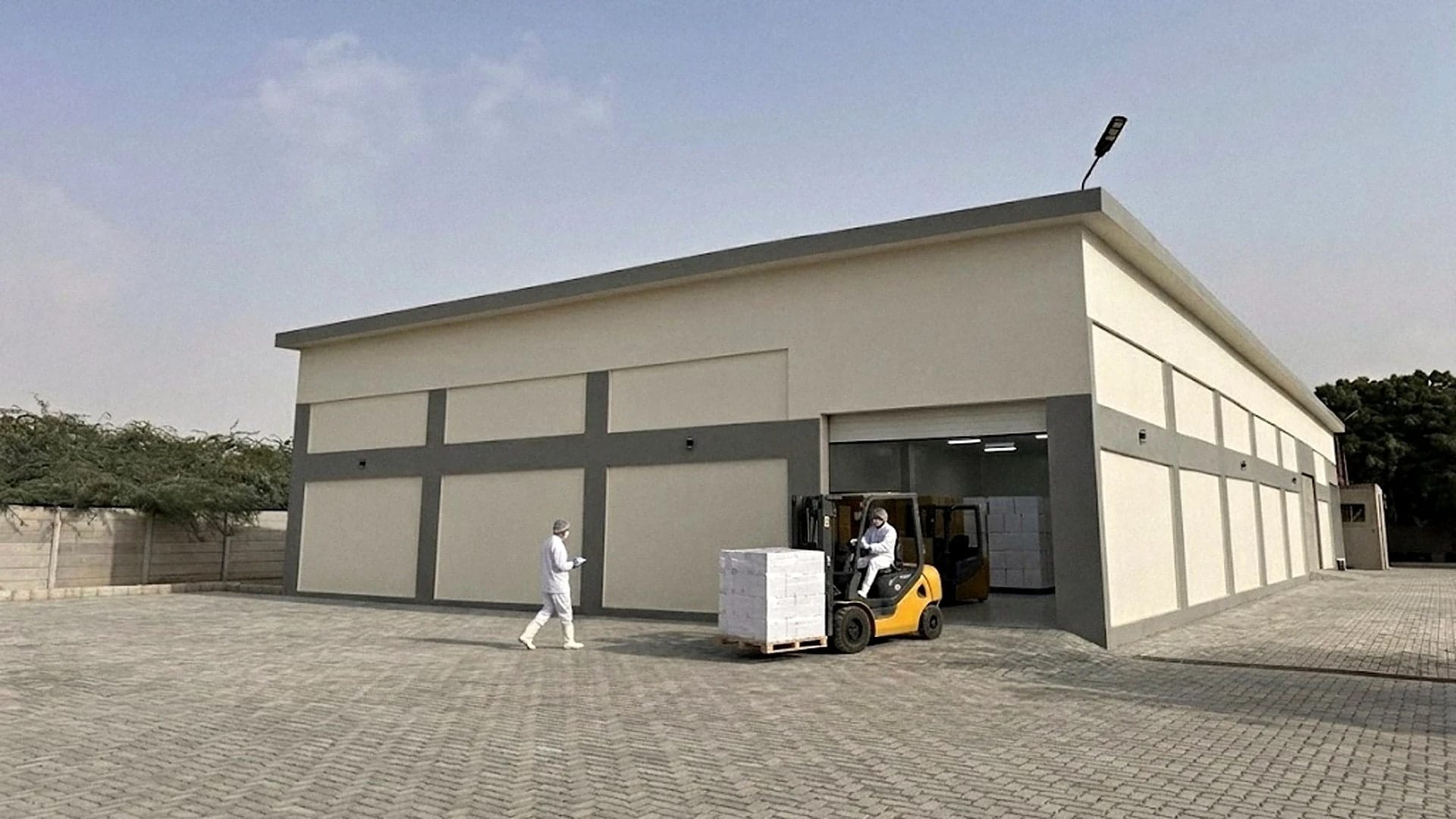Single-storey facility building with a forklift moving a pallet of cartons